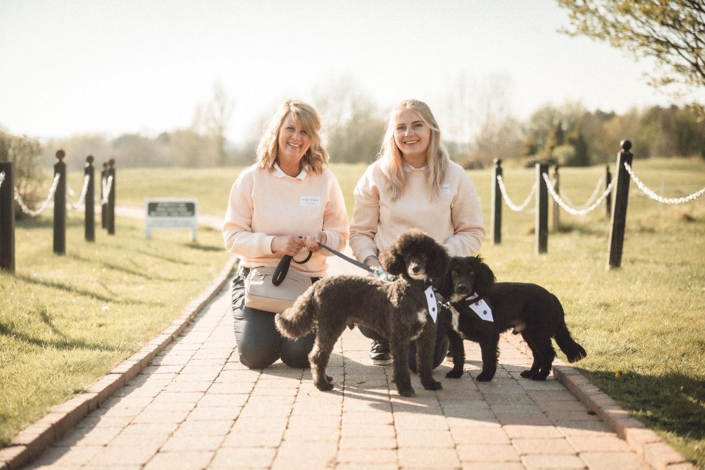 Wedding couple celebrating with their dog during a Waggy Wedding ceremony at Shenstone Golf Club, Aston Wood, UK, 2025.