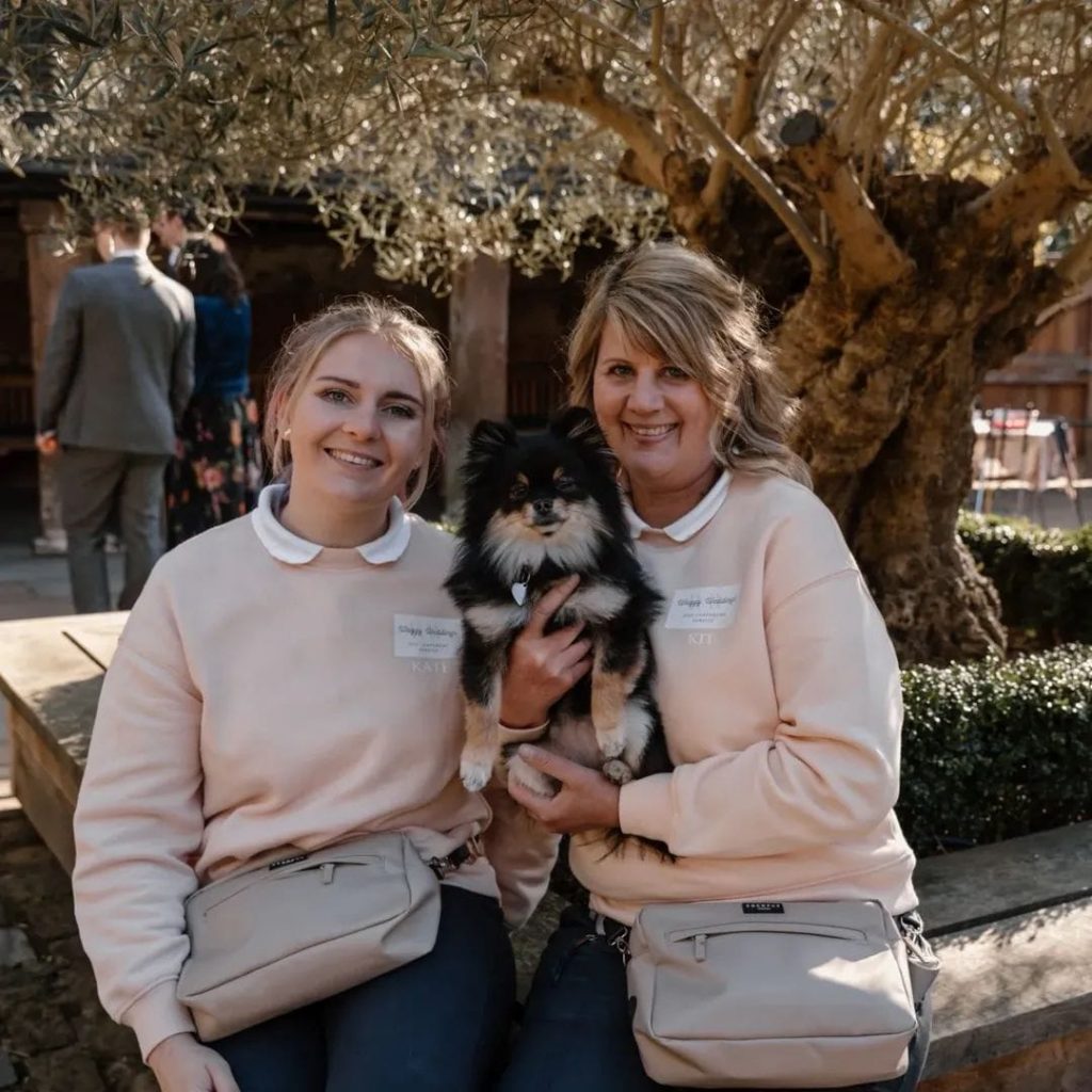 Wedding couple posing with their dog Darcy during a Waggy Wedding ceremony in Cannock, UK, 2025